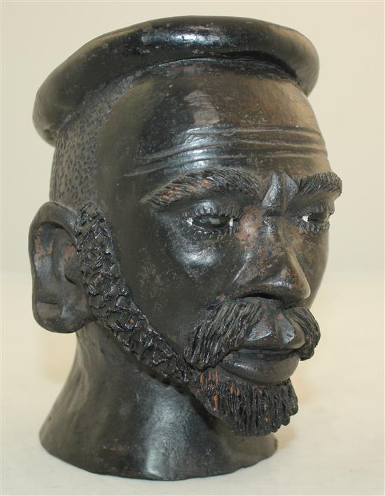 An African painted terracotta jar modelled as the head of a bearded man, 7.5in.